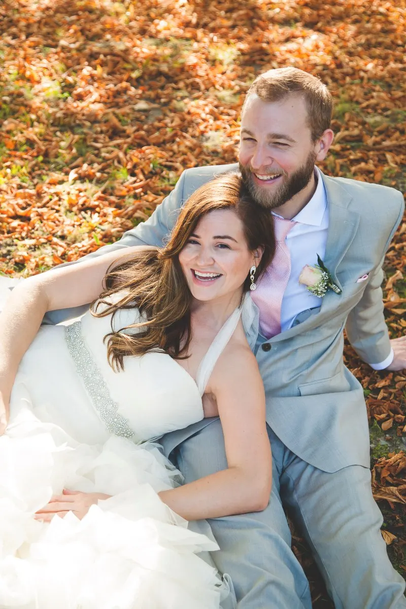 destination germany wedding, american couple sitting in autumn leaves