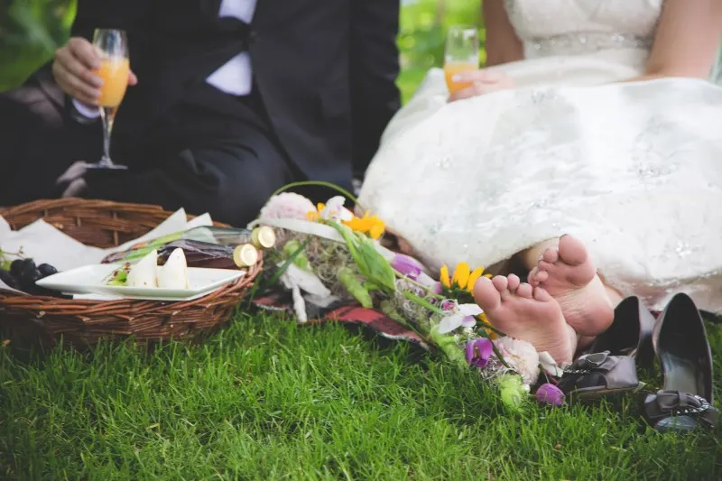 international destination netherlands wedding, bride and groom picnicking on the grass