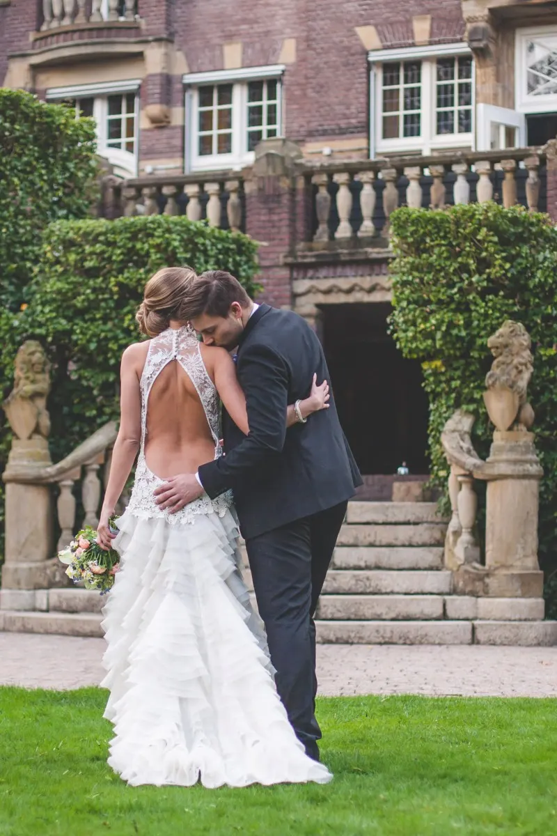 castle bridal portrait, couple embracing in front of a manor
