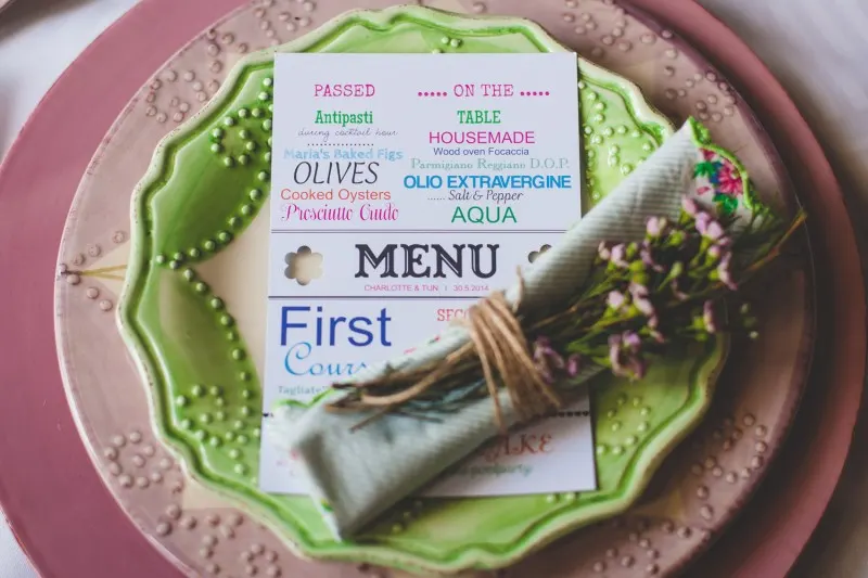 wedding place setting with a menu card, linen napkin and a sprig of lavender