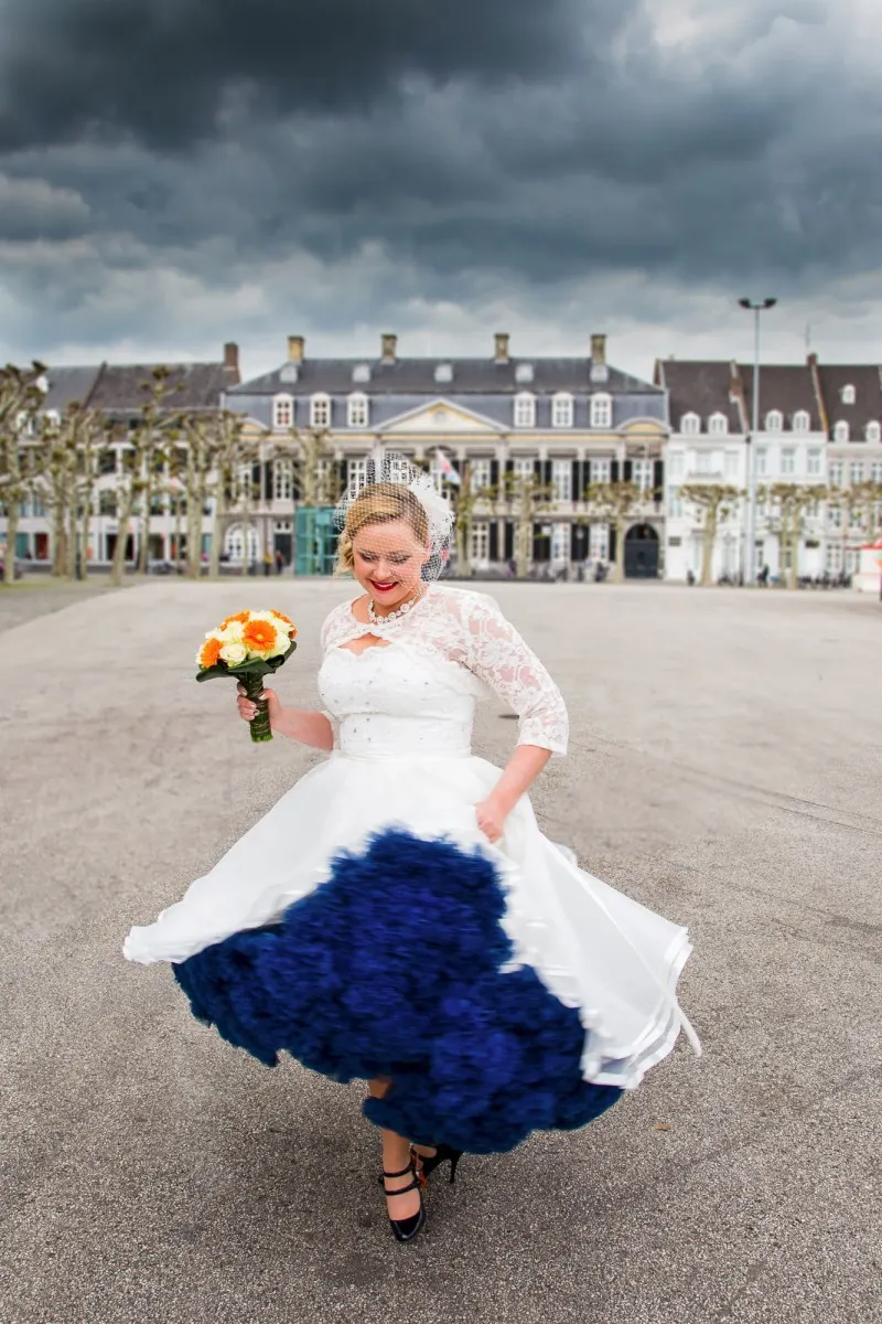 dutch american wedding, bride twirling with a blue underskirt in front of a manor