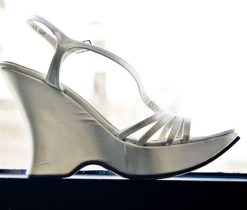 Close-up of silver strappy high-heeled wedding shoes