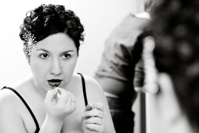 Bride having her makeup applied before the wedding, black and white