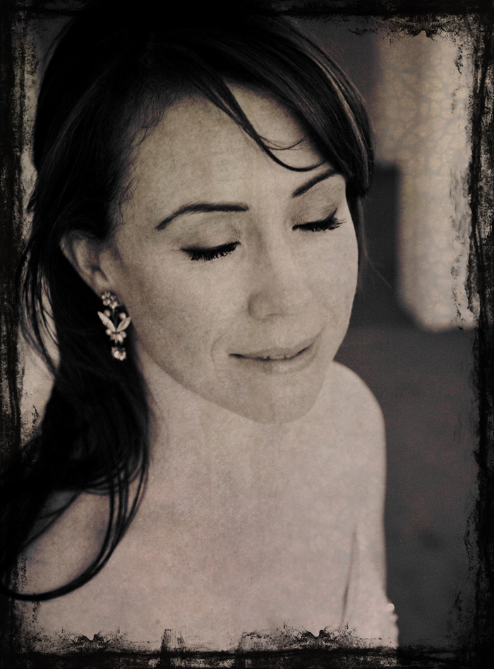 Fine-art portrait of a young woman looking downward, soft sepia toned contest photograph