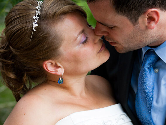 Kara and Stuart share a tender forehead-touching moment during their wedding.