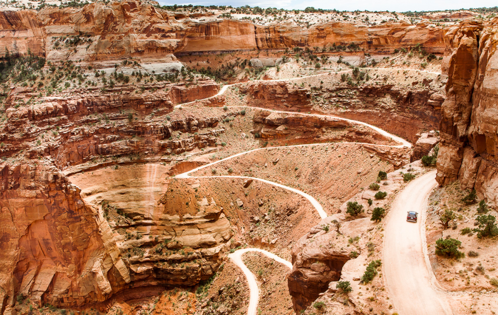 Winding road carved in switchbacks through red rock canyons at Grand View Point in Canyonlands National Park