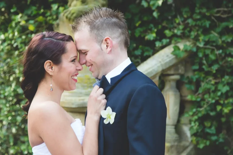 dutch bridal portraits, couple with foreheads touching in front of ivy